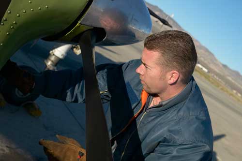 Engineer works on a plane propeller.