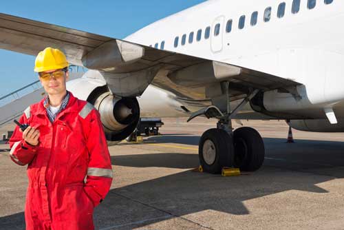 Safety Inspector by a commercial airplane.