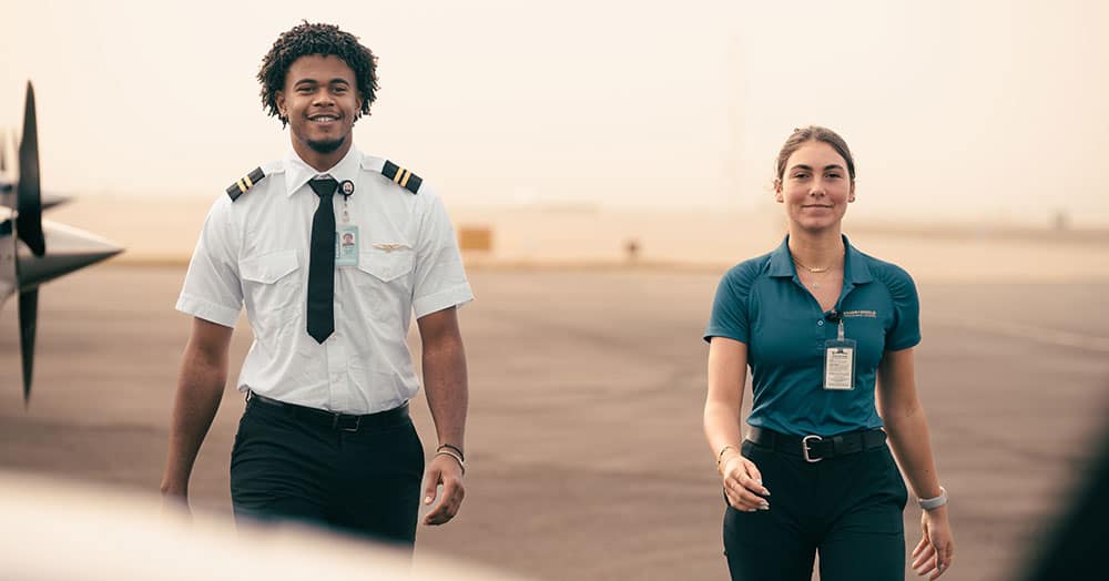  two airplane pilots looking over their shoulders in a jet