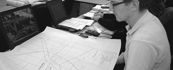 Engineer looks at blueprints